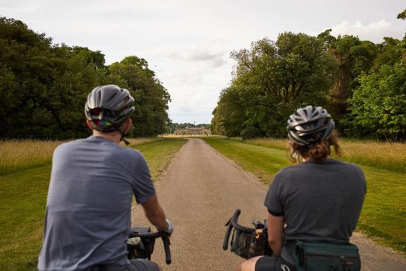 Cyclist riding through the grounds of Holkham Hall