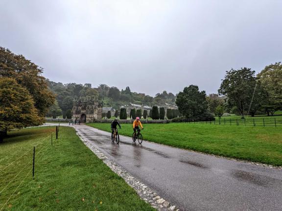 Cyclist riding outside Lanhydrock House